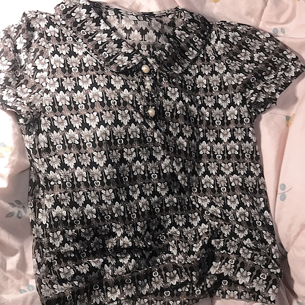 Black short sleeved top with designs all over with pearls